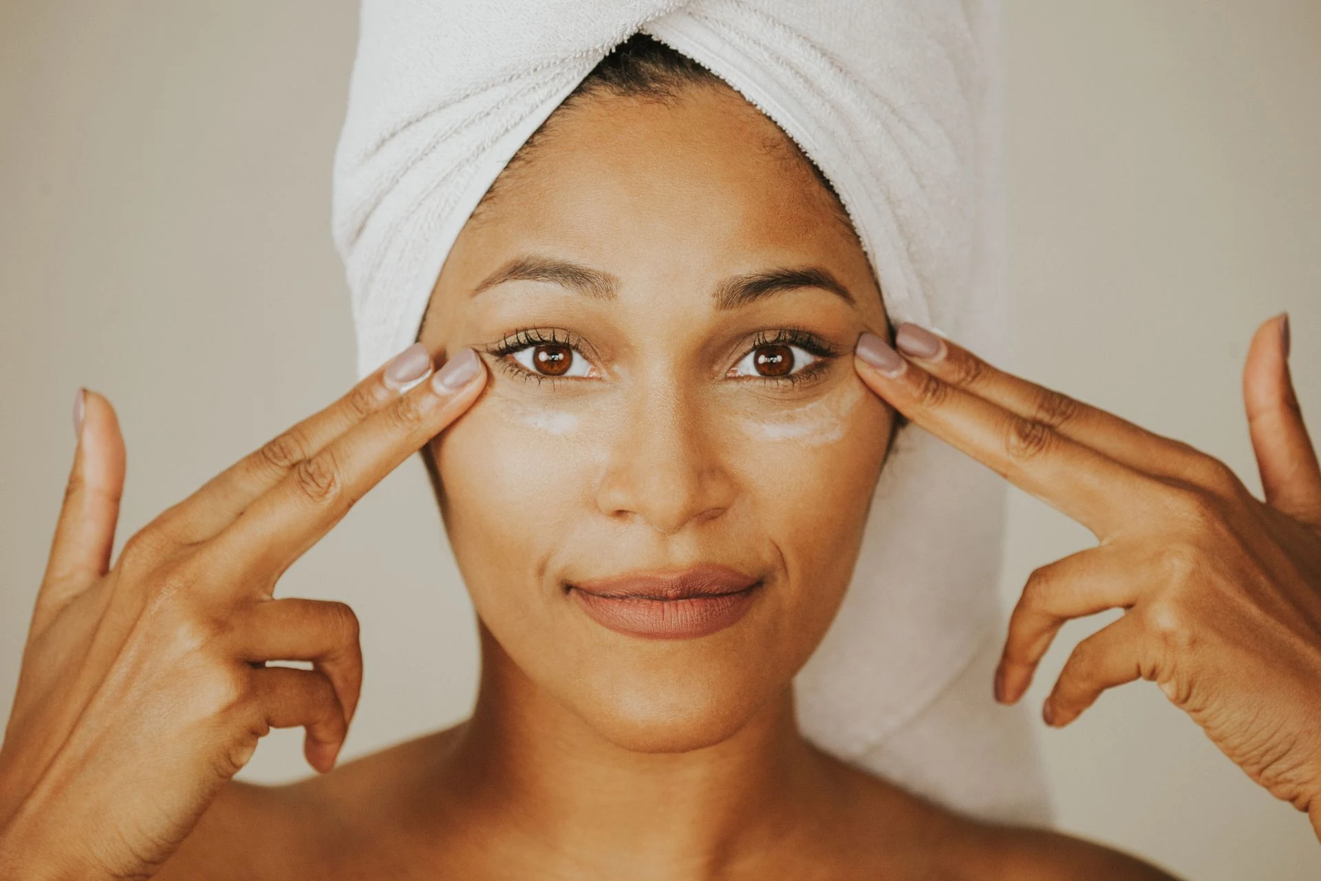 Woman gently applying facial cream